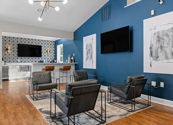 A living room with a blue wall and a television.