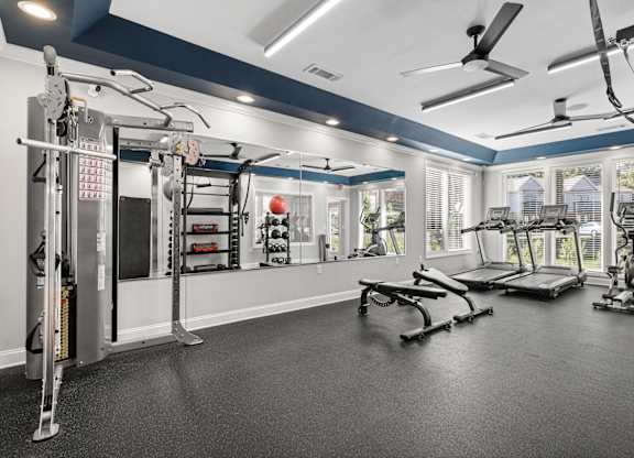 A spacious home gym with a variety of exercise equipment.