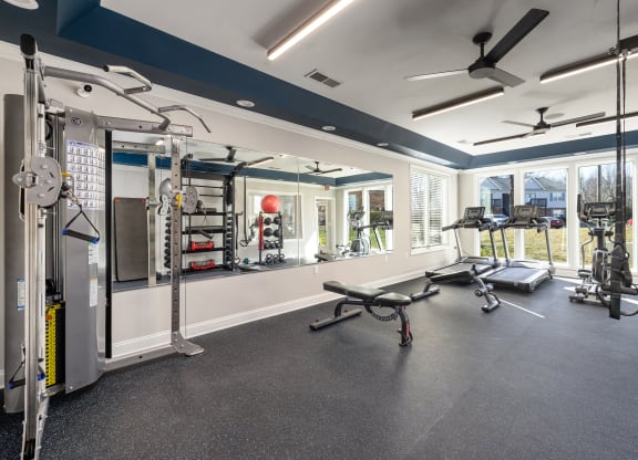 addison point interior resident gym with exercise equipment and a large window