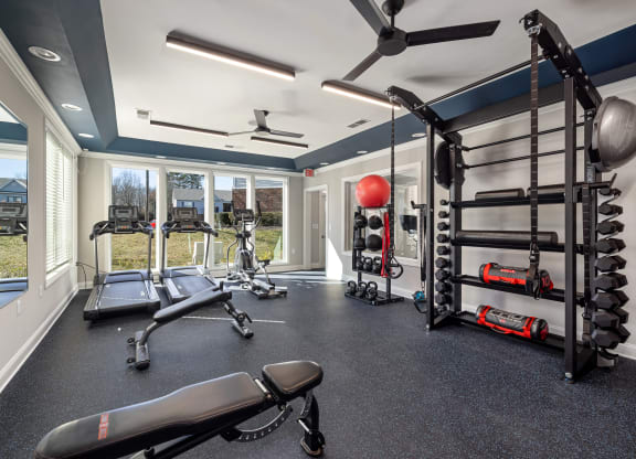addison point interior resident gym with weights and equipment and windows