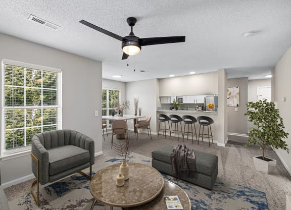 addison point interior staged model an open living room and kitchen with a ceiling fan