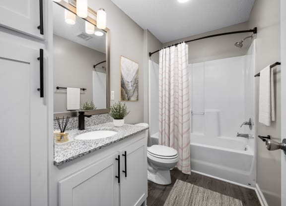 addison point interior staged model an open bathroom with a shower toilet and sink