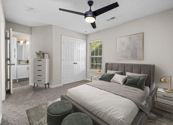 addison point interior staged model bedroom with a bed and a ceiling fan