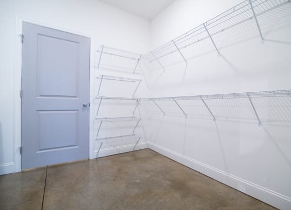 a room with white walls and a blue door in it
