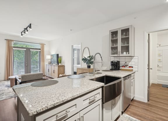 a kitchen and living room with a sink and a counter top