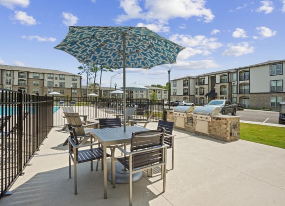 our apartments have a large patio with tables and chairs