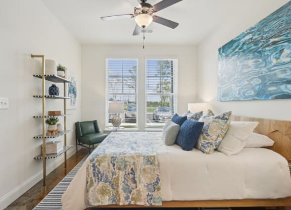 a bedroom with a bed and a ceiling fan