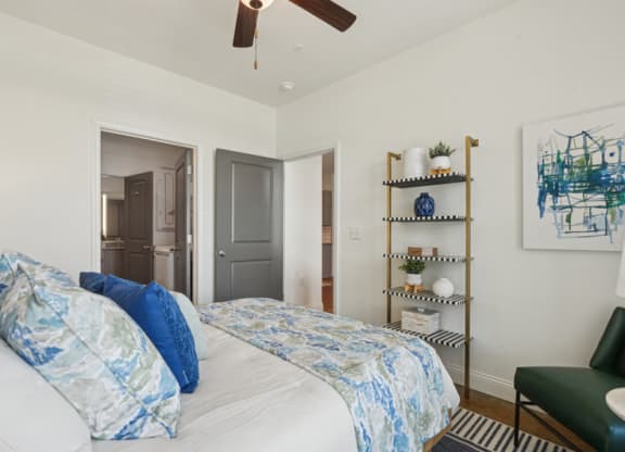 a bedroom with a bed and a ceiling fan