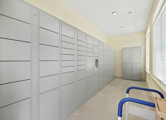 a long hallway with many cabinets and a door