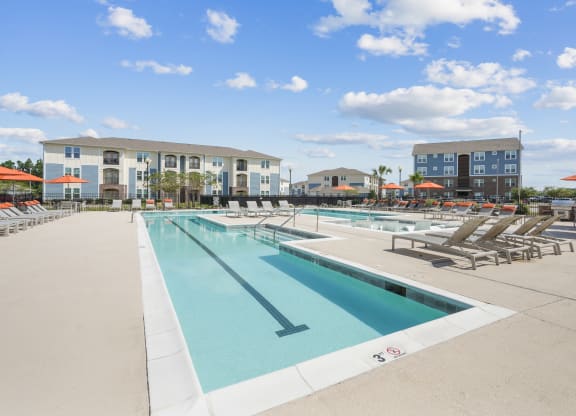 our apartments have a large pool with lounge chairs and umbrellas