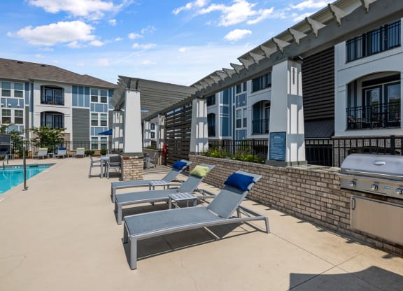 Long pool chairs and grill