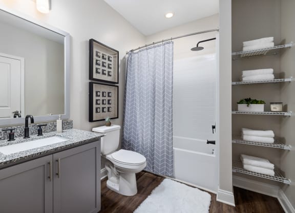 Large bathroom with towel shelves and shower tub