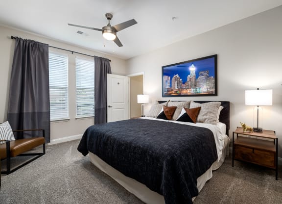 Bedroom with dark blinds and queen bed