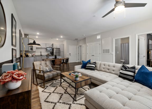Furnished living room with grey sofa and ceiling fan