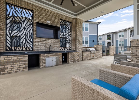 Patio with large tv and chairs