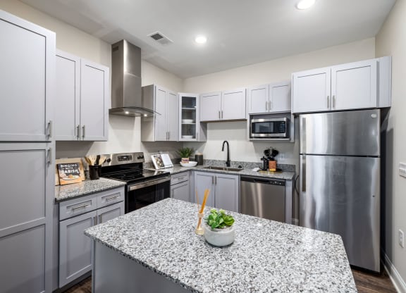 a kitchen with stainless steel appliances and granite counter tops