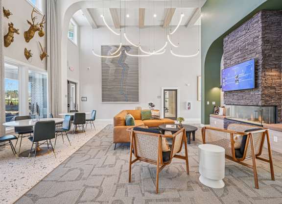 A modern living room with a stone fireplace and a television.