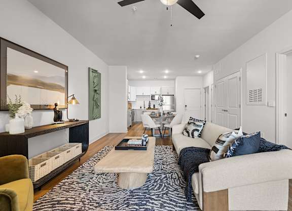 A modern living room with a white sofa and a coffee table.