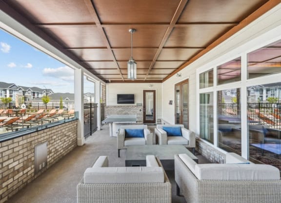 a living room with couches and chairs and a balcony