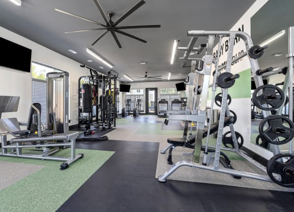a gym with weights and cardio equipment at the flats