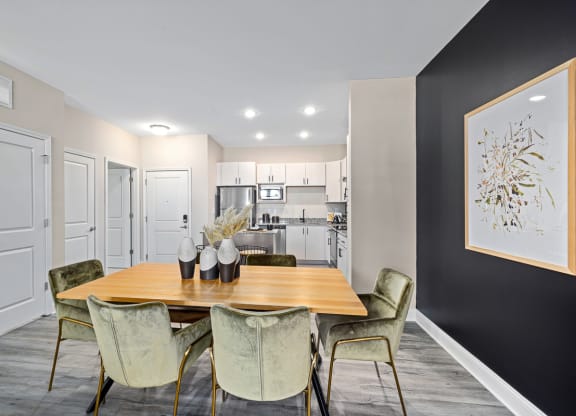 a dining room with a table and chairs and a kitchen
