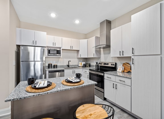 a kitchen with stainless steel appliances and white cabinets
