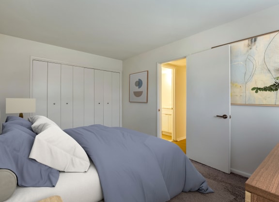 a bedroom with a bed and a door to a bathroom