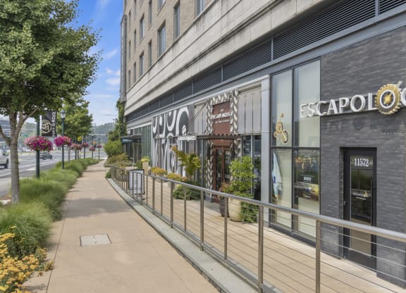 a sidewalk in front of a building with a sign on it