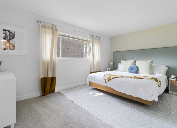 a bedroom with a bed and a window