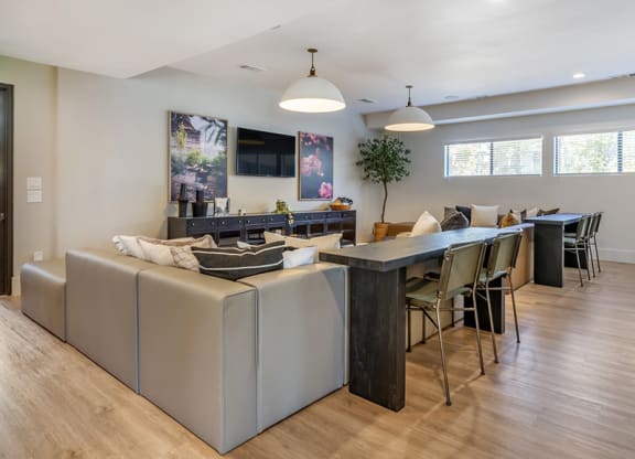 the living room and dining area of a home with a table and chairs