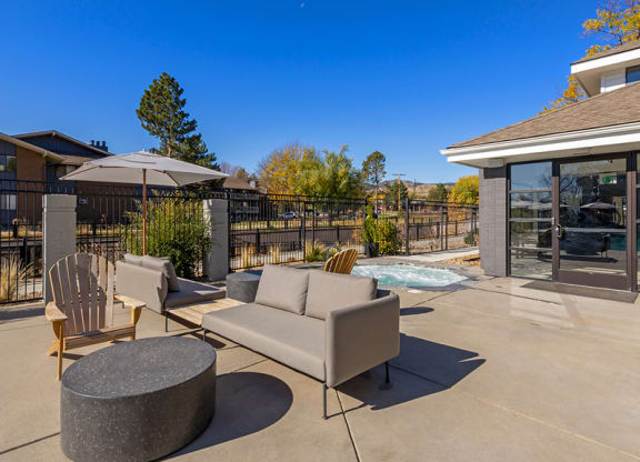 The Magwood patio with chairs and tables and a pool
