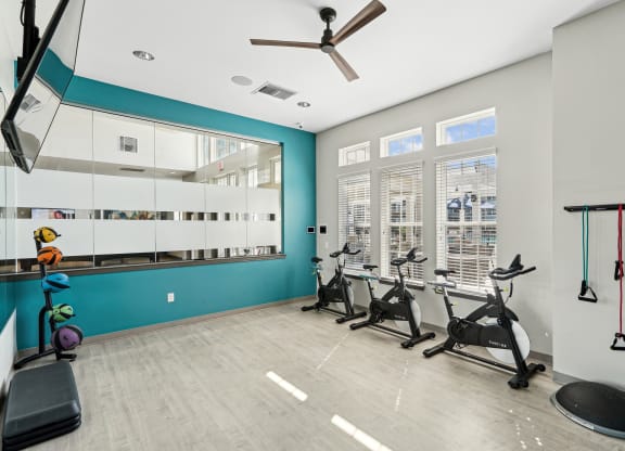 the gym with treadmills and weights at the belgard apartments