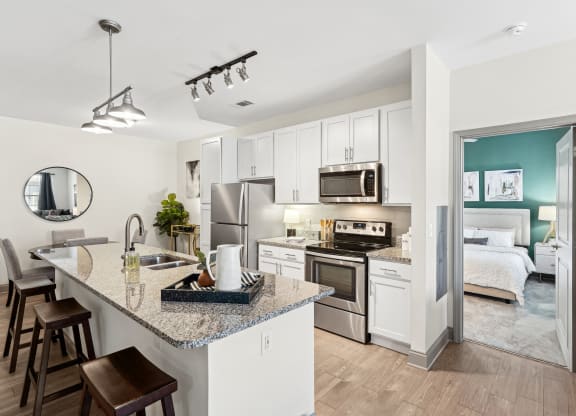 a kitchen with stainless steel appliances and a granite counter top