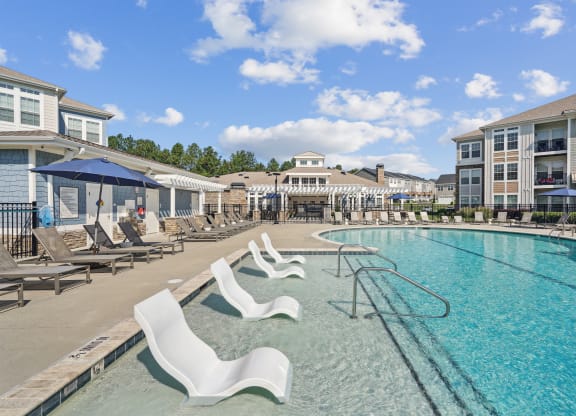 our resort style swimming pool is next to our building with lounge chairs