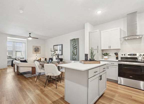 A modern kitchen with a dining table and chairs.