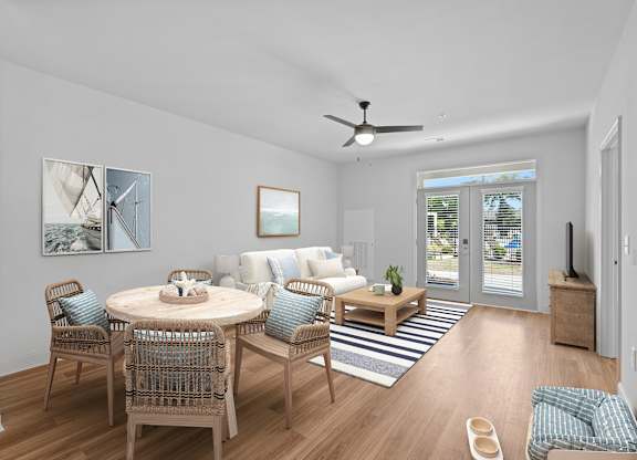 A dining room with a round table and chairs.