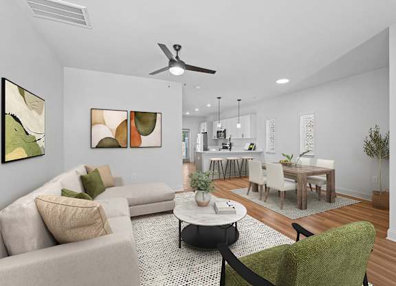 A living room with a beige couch, a green chair, and a coffee table.