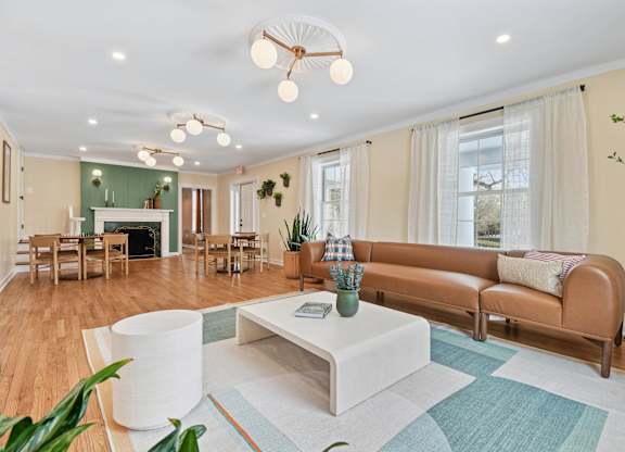 A living room with a white coffee table and a brown sofa.