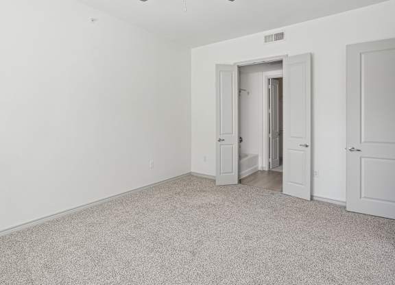 A room with a carpeted floor and white walls.