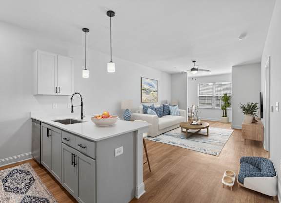 A modern kitchen with a white countertop and grey cabinets.