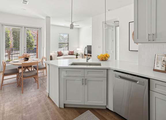 A kitchen with a table and chairs by a window.