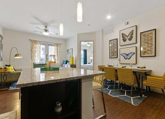 an open kitchen and dining area with a granite counter top and a dining room table