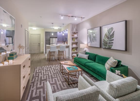 a living room and kitchen with a green couch