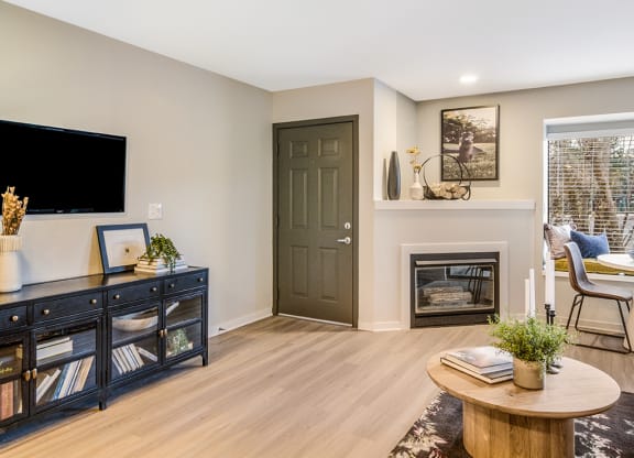 a living room with a fireplace and a tv