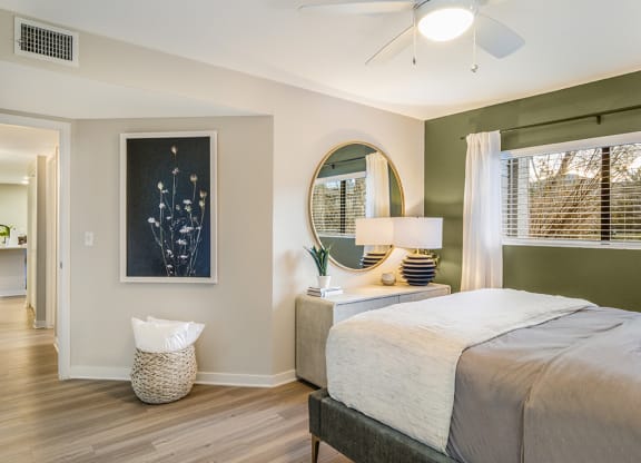 a bedroom with a large bed and a ceiling fan