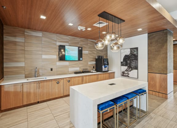 a large kitchen with a white counter top and a sink