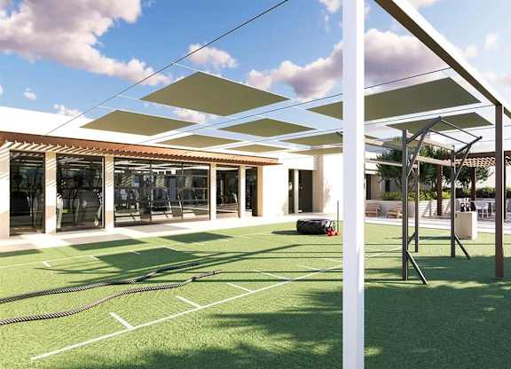 Outdoor fitness space with turf and training equipment at Garden at 3Roots Apartments, San Diego, CA