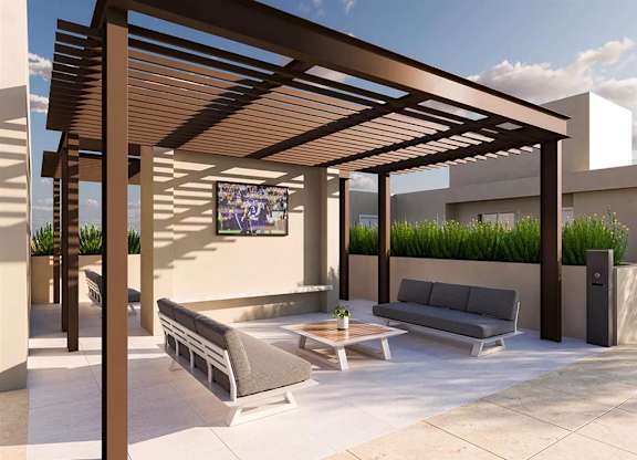 Rooftop terrace with pergola and lounge seating at Garden at 3Roots Apartments, San Diego, California