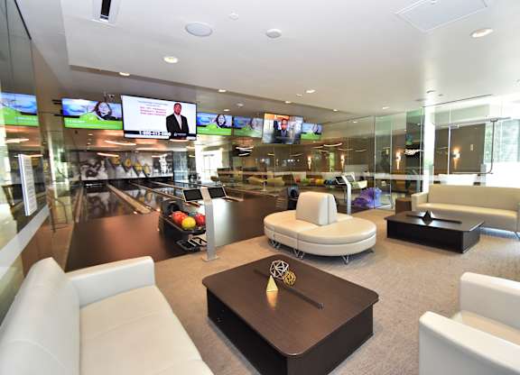 Private bowling lounge with seating and television screens at 360 Luxury Apartments, California, 92122