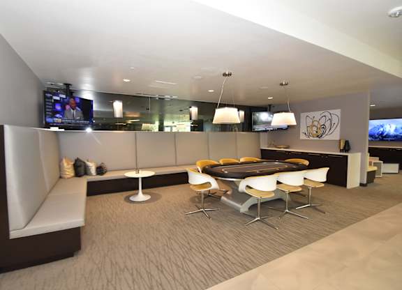 Suite with banquette seating and gaming table at 360 Luxury Apartments, San Diego, CA